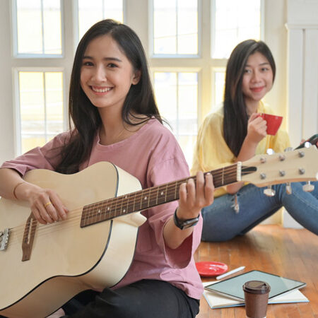 teenage-girls-are-singing-and-playing-guitars-they-NJUHDBF.jpg